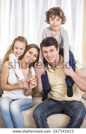 Happy to be a family. Portrait of happy family with kids on the couch.