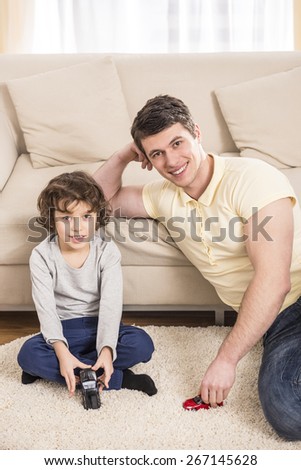 Father and son playing in living room.