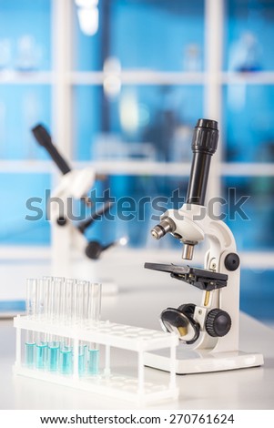 Laboratory, chemistry and science concept.  Microscopes and test tube on table.