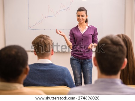 Business meeting. Teamwork concept. Young business woman with speech to colleagues.