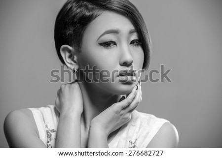 Young beautiful gorgeous woman dressed casual posing in the studio.  Black and white fashion portrait.