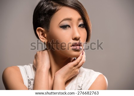 Young beautiful gorgeous woman dressed casual posing in the studio on dark background. Fashion portrait.