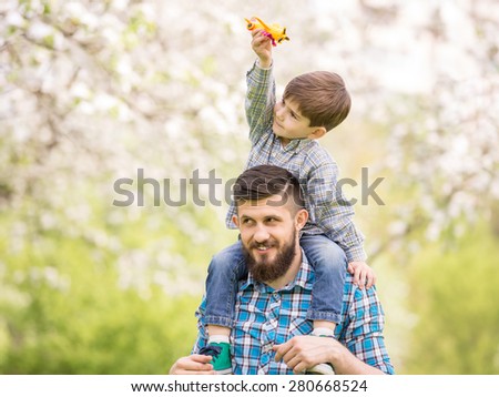 Little boy and his dad enjoying their time together outside in nature.