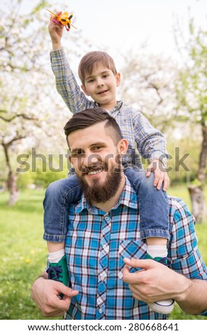 Little boy and his dad enjoying their time together outside in nature.