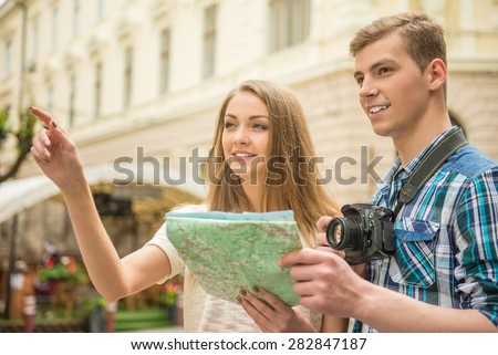 Young handsome man asks girl to show him how to get to the centre. Journey.