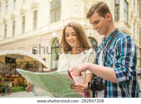 Young handsome man asks girl to show him how to get to the centre. Journey.