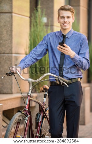 Businessman in suit going to work on his bicycle. Healthy lifestyle concept.