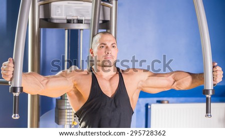 Male bodybuilder doing heavy weight exercise for chest.