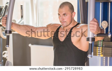 Male bodybuilder doing heavy weight exercise for chest.