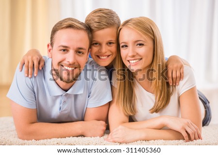 Mother, father and son together. Happy family are smiling to the camera.