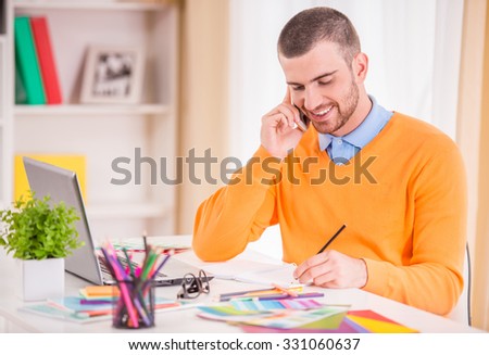 Portrait of a young businessman designer working in office
