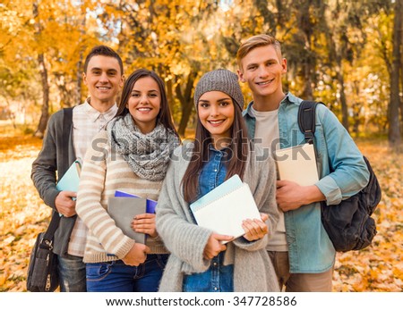 Group of young people students while walking autumn park