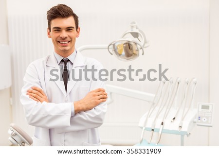 Portrait of a dentist. Young man at his workplace in the dental clinic