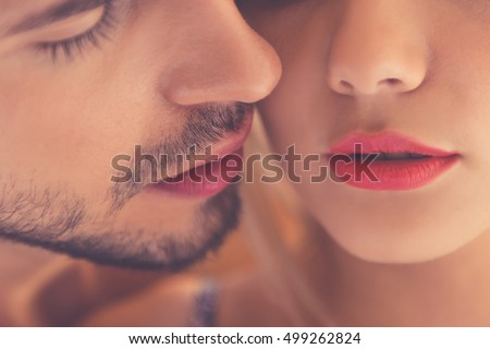 Close-up of beautiful passionate couple kissing while having sex