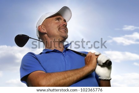 Smiling golfer holding golf club over shoulder