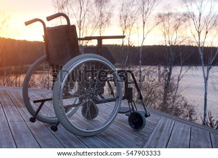 Empty wheelchair standing in a park