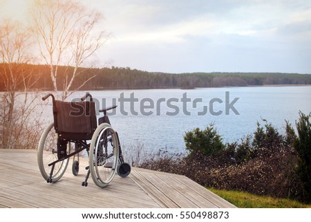 Empty wheelchair standing in a park