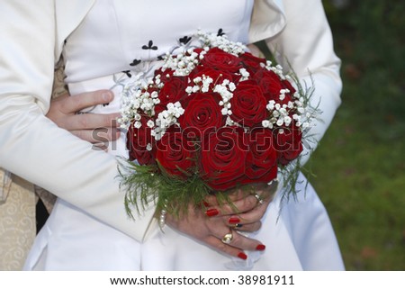 Bride and groom holding hands, bride holding bouquet