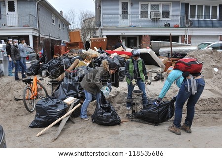 QUEENS, NY - NOVEMBER 11: Volunteers cleaning debris and sand in the Rockaway beach residential area from Hurricane Sandy in Queens, New York, U.S., on November 11, 2012.