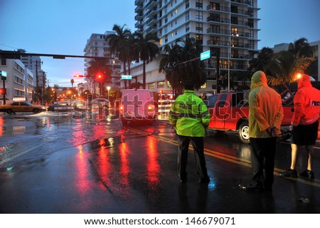 MIAMI BEACH, FL - JULY 18: Cars moving on flooded streets and roads of Miami South Beach  after heavy rains in Florida July 18, 2013 in Miami Beach, Florida