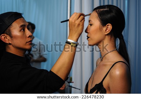 NEW YORK, NY - OCTOBER 25: Models getting ready backstage with makeup and hair during Made in the USA Spring 2015 lingerie showcase preparations at the Center 548 on October 25, 2014 in New York City