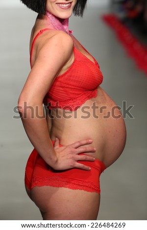NEW YORK, NY - OCTOBER 25: A pregnant model walks runway during You! Lingerie Spring 2015 show during Lingerie Fashion Week at the Center 548 on October 25, 2014 in New York City.