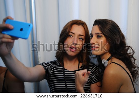 NEW YORK, NY - OCTOBER 25: Models making selfie snapshots backstage during Made in the USA Spring 2015 lingerie showcase preparations at the Center 548 on October 25, 2014 in New York City.