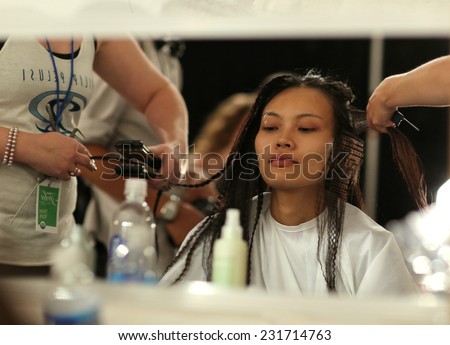 NEW YORK, NY - SEPTEMBER 06: A model has her hair done backstage at Venexiana during Mercedes-Benz Fashion Week Spring 2015 at Lincoln Center on September 6, 2014 in NYC