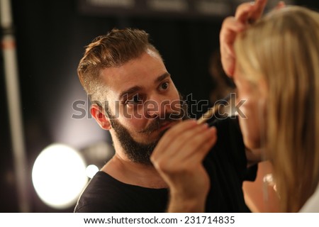 NEW YORK, NY - SEPTEMBER 06: A model has her make-up done backstage at Venexiana during Mercedes-Benz Fashion Week Spring 2015 at Lincoln Center on September 6, 2014 in NYC