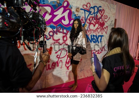 LONDON, ENGLAND - DECEMBER 02: Official TV crew shooting Adriana Lima backstage at the annual Victoria\'s Secret fashion show at Earls Court on December 2, 2014 in London, England.