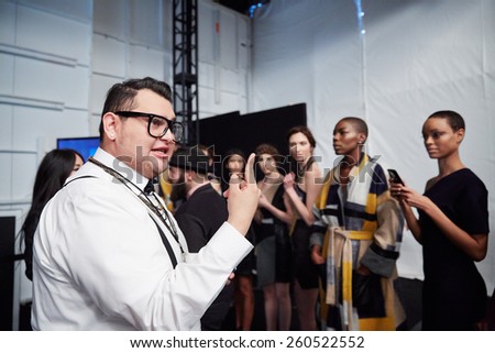 NEW YORK, NY - FEBRUARY 19: A PR manager working backstage at the New York Life fashion show during MBFW Fall 2015 at Lincoln Center on February 19, 2015 in NYC.