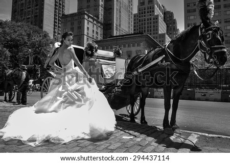 NEW YORK - June 13: Model Kalyn Hemphill pose in front of horse carriage at the Irina Shabayeva SS 2016 Bridal collection photoshoot on June 13, 2015 in New York, USA