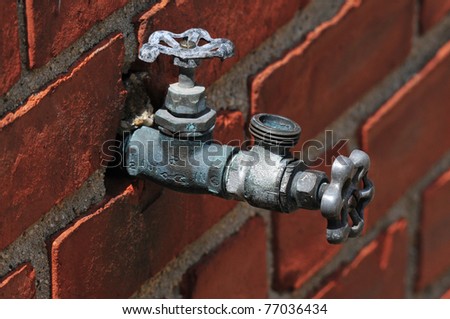 Water valve with brick wall background