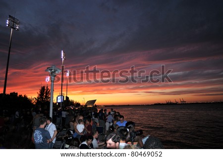 STATEN ISLAND NY - JULY 4: Sunset with unidentified people waiting for 4th of July Independence Day firework show as annual event to celebrate the birth of United States, July 4, 2011 in Staten Island, New York.