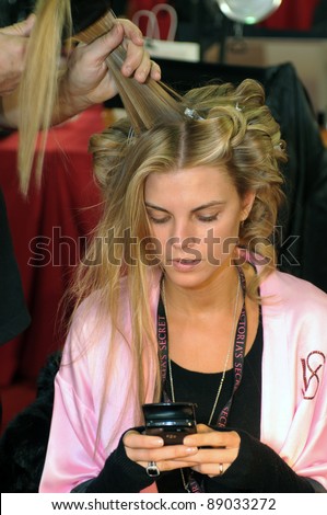 NEW YORK - NOVEMBER 10: Victoria\'s Secret model  Maryna Linchuk getting ready backstage  during the 2010 Victoria\'s Secret Fashion Show on November 10, 2010 at the Lexington Armory in New York City.