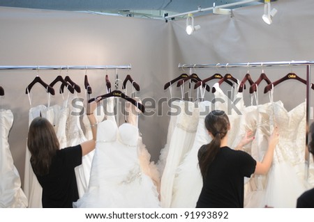 NEW YORK - OCTOBER 17: Dressers team working backstage at the Winnie Couture Bridal Collection for Spring/ Summer 2012 during NY Bridal Fashion Week on October 17, 2011 in New York, USA