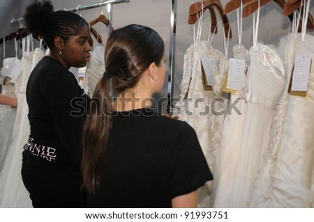 NEW YORK - OCTOBER 17: Dressers team working backstage at the Winnie Couture Bridal Collection for Spring/ Summer 2012 during NY Bridal Fashion Week on October 17, 2011 in New York, USA