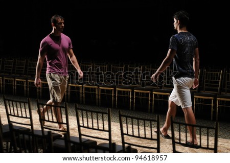 NEW YORK, NY - SEPTEMBER 15: Two male models walking runway at rehearsal for the runway at the GULI Spring/Summer 2012 Collection at Cipriani 42nd Street on September 15, 2011 in New York City.