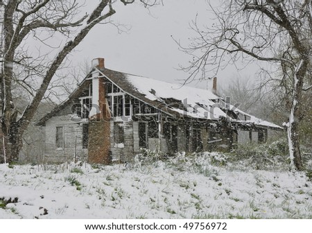 Old destroyed house in snow