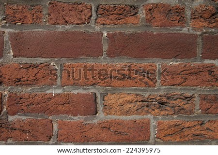 Close up of clay brick wall with black carbon deposits in need of cleaning and restoration