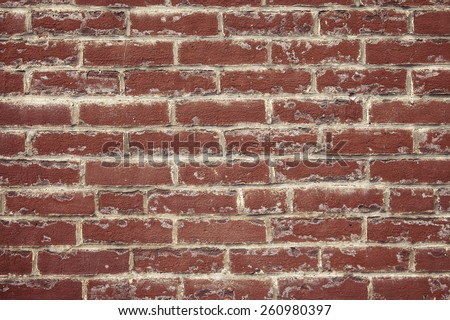 Red clay brick wall with white deposits and mortar smears, new construction cleaning issues