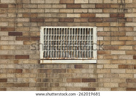 Vent on brick building, building restoration issues, black deposits, staining, and rust