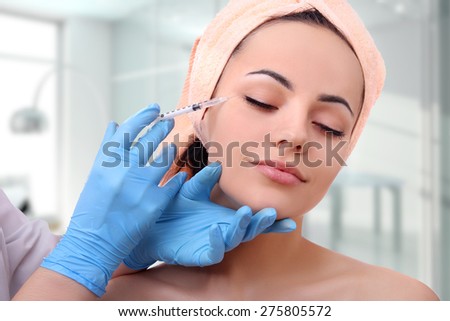 Beautiful girl on rejuvenation procedure in beauty clinic, filler injection.