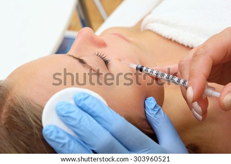 Beautiful girl on rejuvenation procedure in beauty clinic filler injection.