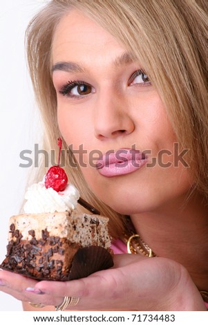 The beautiful girl an eating part of a pie on the isolated white background