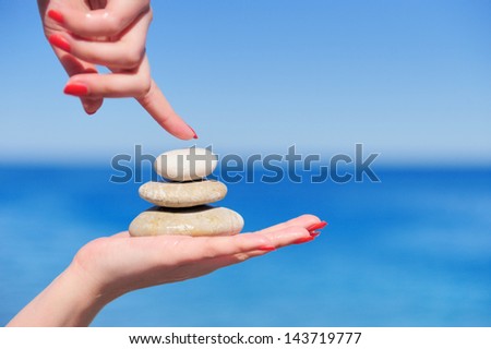 Stones in a hand on a background of the dark blue sky