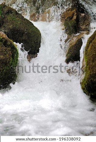 Mountain waterfall. Fast stream water in the mountain forest