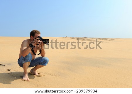 Young photographer taking photos at the beach