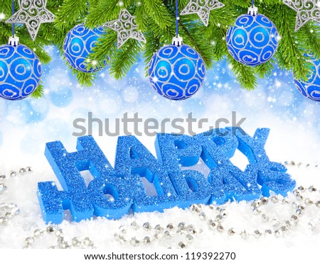 Inscription of happy holidays is on snow with christmas decorations