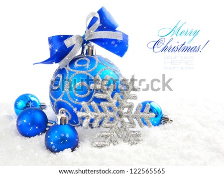 Christmas blue ball is with baubles on snow